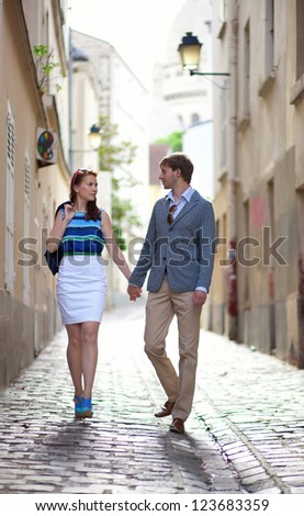 Romantic couple walking on a street of Montmartre in Paris