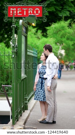 Beautiful couple near the metro station in Paris