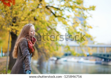 Beautiful young girl enjoying autumn day in Paris