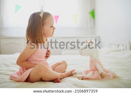 Image, Stock Photo Little blonde girl playing and holding her young parents hand.