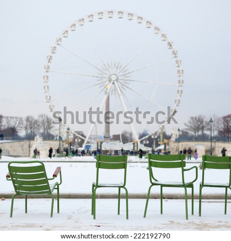 Winter in Paris. Chairs in Tuileries garden and snow
