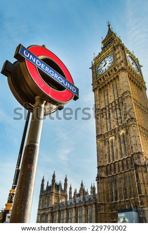 LONDON, UK - OCTOBER 31, 2014: London Underground subway sign in front of famous Clock Tower (now officially called the Elizabeth Tower) with bell Big Ben at Westminster in London.