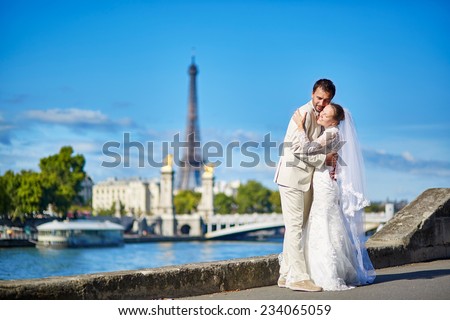 Beautiful just married couple in Paris near the Eiffel tower in Paris