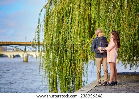 Young dating couple in Paris near the Seine on a nice spring day