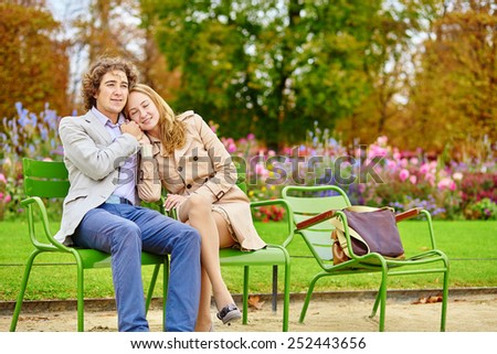 Young romantic couple having a date in the Tuileries garden of Paris