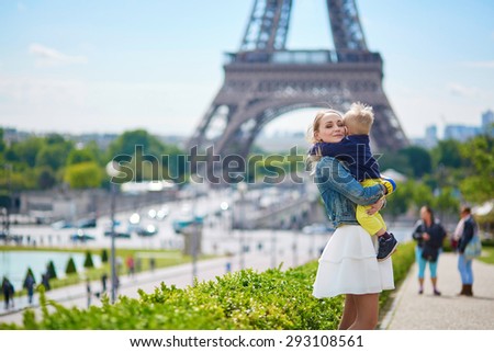 Happy family of two having fun together in Paris near the Eiffel tower
