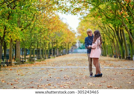 Young romantic couple in Paris, enjoying beautiful autumn day in the Luxembourg garden
