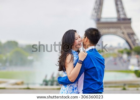Young romantic Asian couple on Trocadero view point near the Eiffel tower in Paris, France