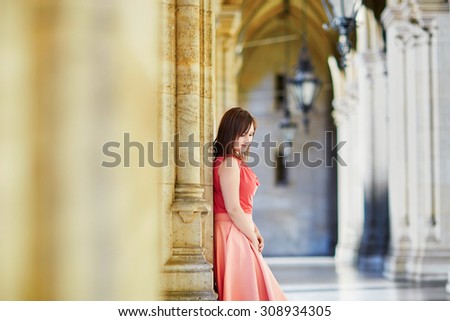 Beautiful young tourist walking in the street near the Rathaus (city hall) in Vienna, Austria