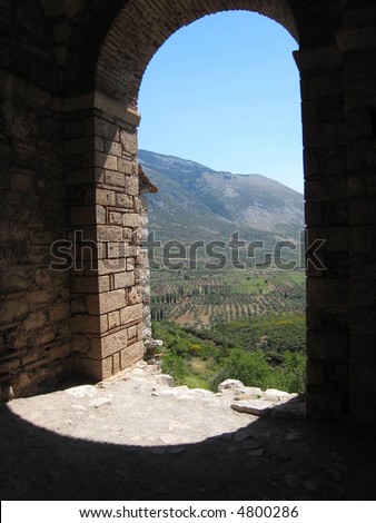 A doorway to nowhere on Mount Helikonas, Greece. A beautiful arched doorway that just dropped off at the edge. Great views of the Greek countryside just beyond it.