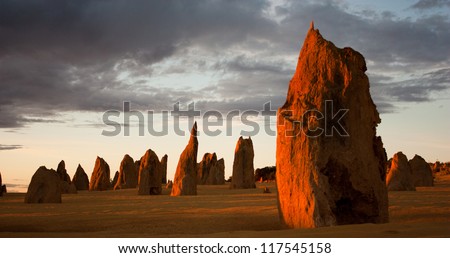 Limestone formations glowing red at last light in the Pinnacles desert in Nambung National Park, Western Australia