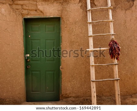 Chili ristra hanging from ladder, New Mexico