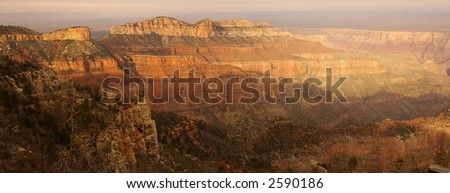 A panoramic view of the Grand Canyon from Point Imperial viewpoint on North Rim lit by setting sun.