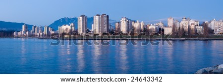 High-rises at English Bay, Vancouver, Canada are lit by the last rays of setting sun.