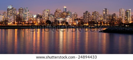 Highrises glow in gathering dusk on a winter Vancouver evening by the English Bay