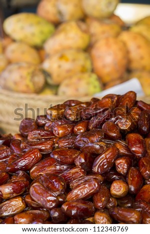 Close view of a bunch of dried date fruits on a table.