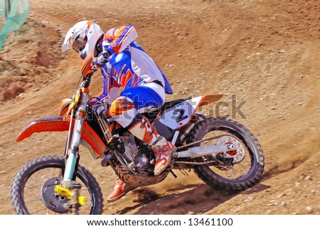 Motorcycle driver sliding on the dirt track.