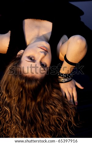 view of a beautiful woman on top of a sports car.
