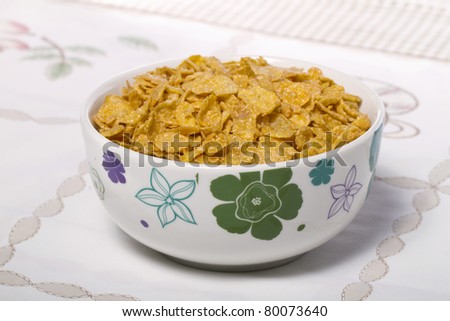 View of a bowl of cereals on top of a table.