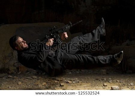 View of a contracted type killer agent in middle air with a machine gun.