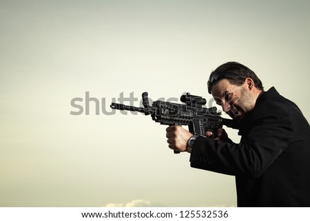 View of a contracted type killer agent wandering with a jacket and machine gun.