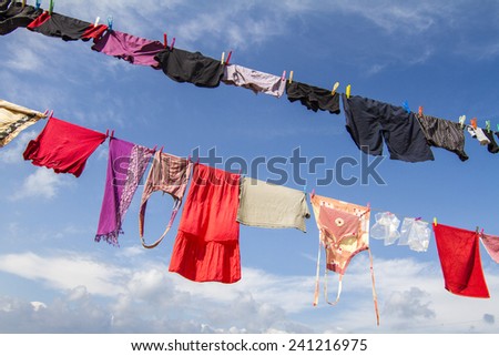 Close up view of outdoor clothing hanging on the beach.