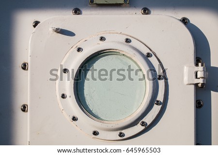 Close up view of aTall Ships metal door with round window. Stok fotoğraf © 