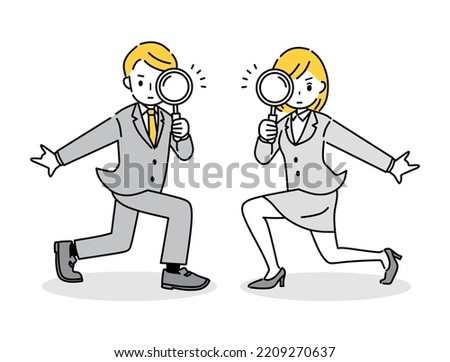 Business person holding a magnifying glass.