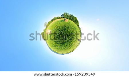 Stereographic projection of a green field with trees. 360 degree panorama. Globe panorama.