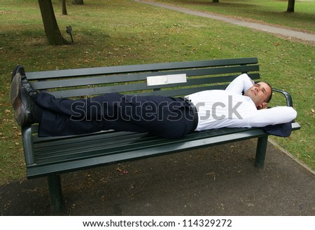 Man lying on a park bench