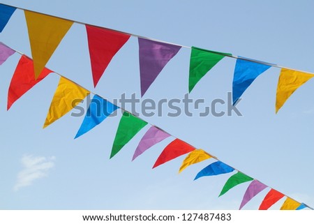 Multi Colored Triangular Flags Hanging In The Sky At An Outdoor ...