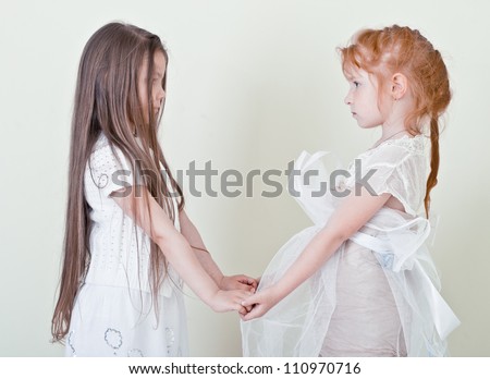 Two little girls holding hands. Girlfriend.