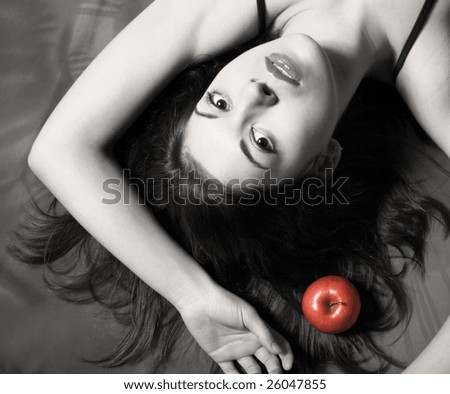 The black-white image of the girl with the dismissed hair and a red apple.