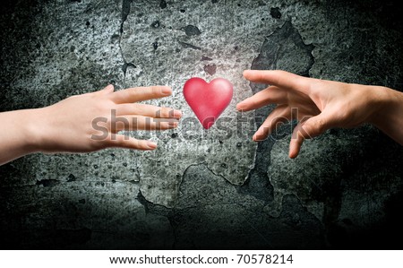 Two hands reach for the heart symbol. A symbol of health. Symbol valentines.