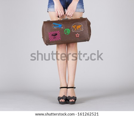 Retro bag in the hands of a woman with long legs.