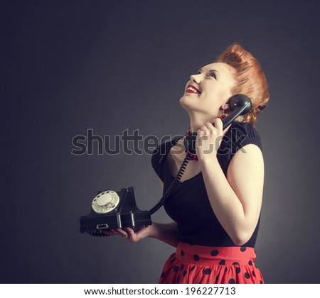 Cheerful woman talking on land line phone. Photo in retro style