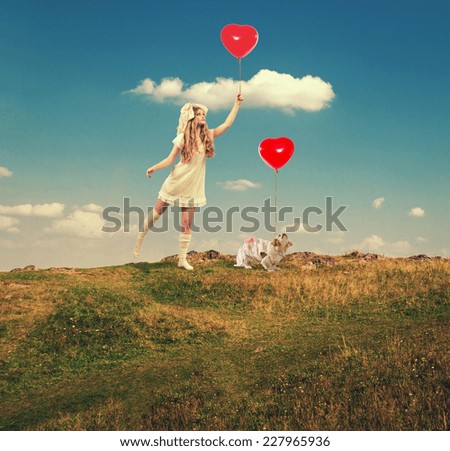 The girl in the image of the doll walks with dog and balloons outdoors.