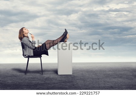 Young businesswoman dreaming sitting on a chair in the open air.