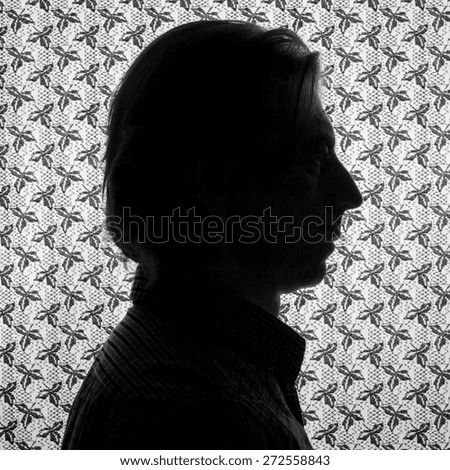 Silhouette portrait of a man in profile.