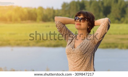 Portrait of a beautiful middle-aged woman , enjoying nature.