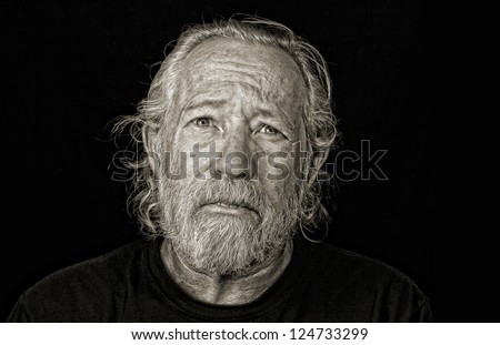 Stressed out older man isolated against black sepia toned