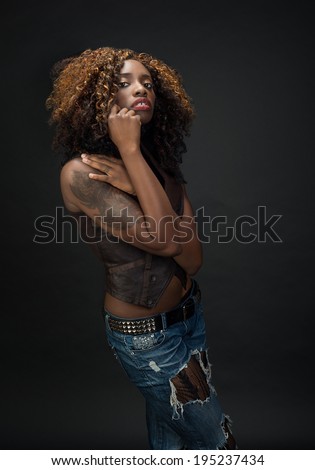 Gorgeous African American woman with wonderful hair and amazing eyes against a dark background