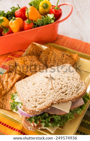Healthy lunch sandwich with ham turkey lettuce tomato cheese and chips