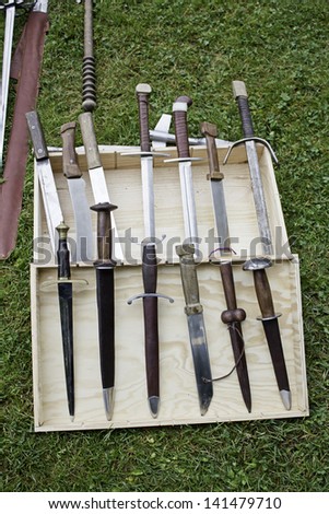 Medieval swords in wooden box, weapons and war