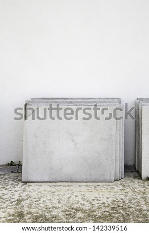 Marble tombstones on cemetery wall, reconstruction and construction