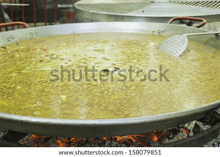 Paella in restaurant cooking, catering and feeding