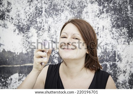 Woman giving wrinkle face cream, beauty