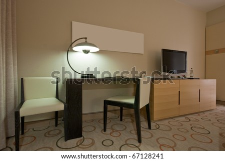 Study room with writing desk armchair and lcd tv set