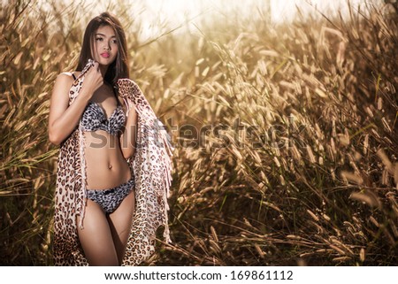 Sexy Asian Girl in bikini plays with white Fabric