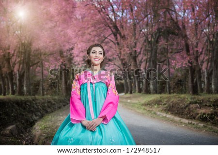 Hanbok: the traditional Korean dress and beautiful Asian girl with sakura